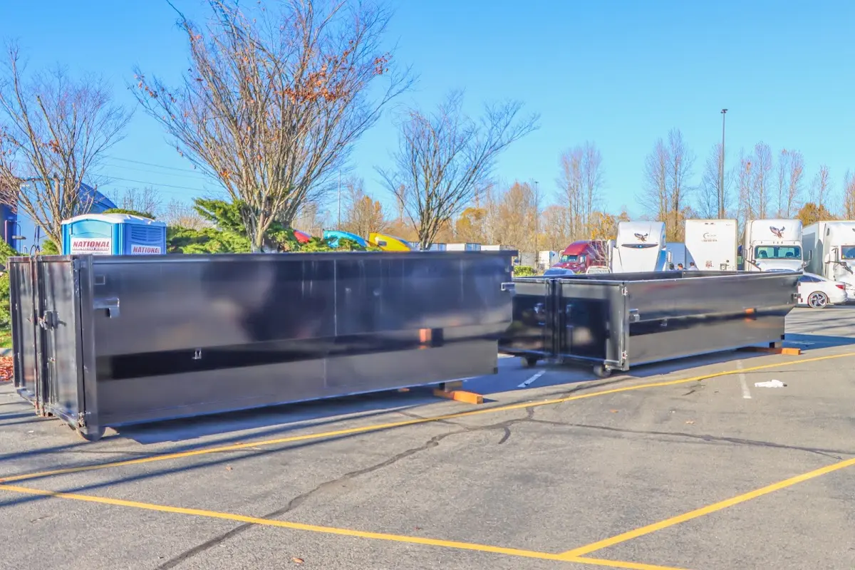 Professional dumpster rental service with roll-off container on residential driveway in Arnold